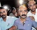 Suspended police officer Sanjeev Bhatt, centre, is escorted after his arrest by police in Ahmadabad on Friday. AP