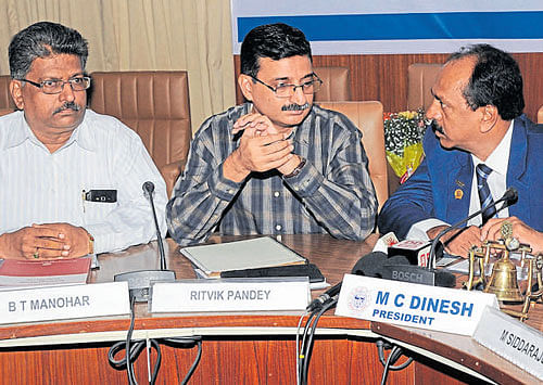 B T Manohar, Chairman, Sales Tax Committee, FKCCI, Commissioner of Commercial Taxes, Ritvik Pandey and  FKCCI president, M C Dinesh at an interaction in Bengaluru on Monday. dh photo