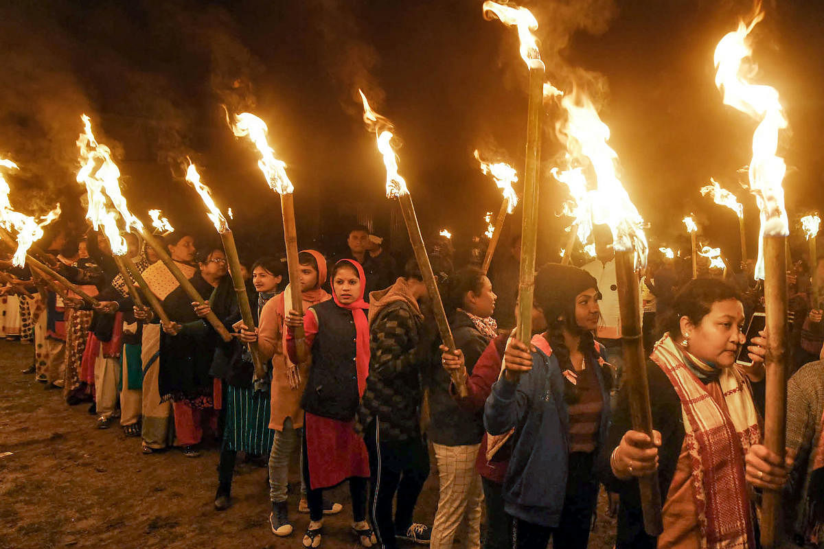 Activists of All Assam Students Union take part in a torch rally against the amended Citizenship Act. (Credit: PTI)