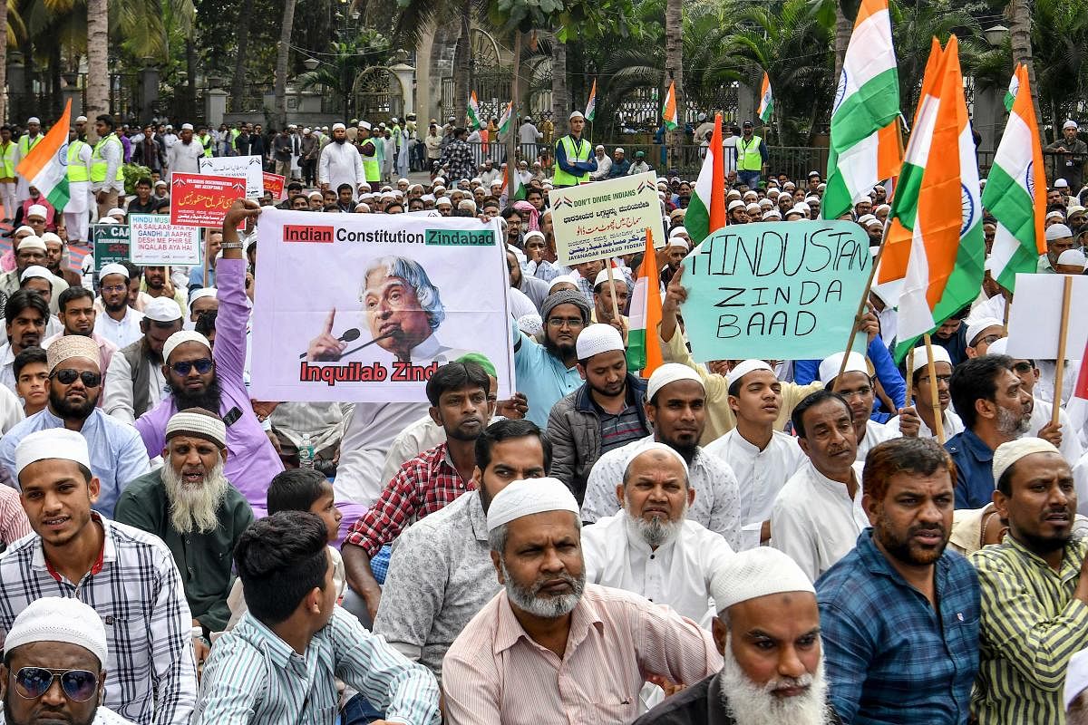 People belonging to the Muslim community hold placards during a protest rally against the Indian government's Citizenship Amendment Act (CAA) (AFP Photo)