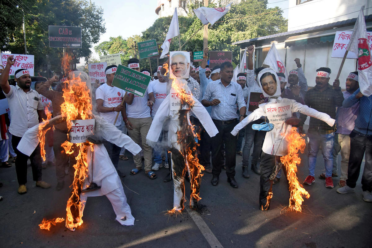 Activists from the All Assam Students Union (AASU) burning effigies depicting India's Home Minister Amit Shah, Prime Minister Narendra Modi and Chief Minister of Assam Sarbananda Sonowal during a protest against the Citizenship Amendment Bill. (Reuters Ph