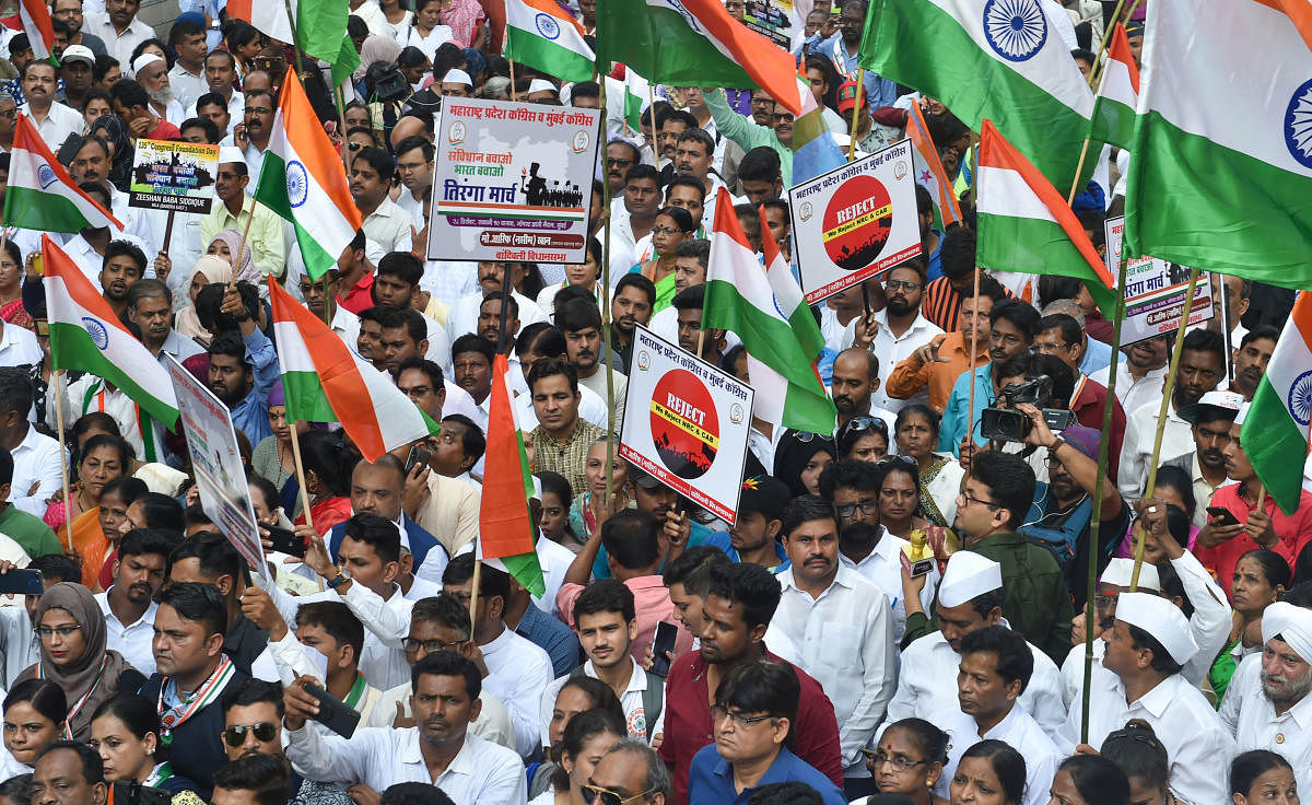 Congress party workers participate in a protest march 'Shanti March' to oppose NRC and CAA in Mumbai. (PTI Photo)