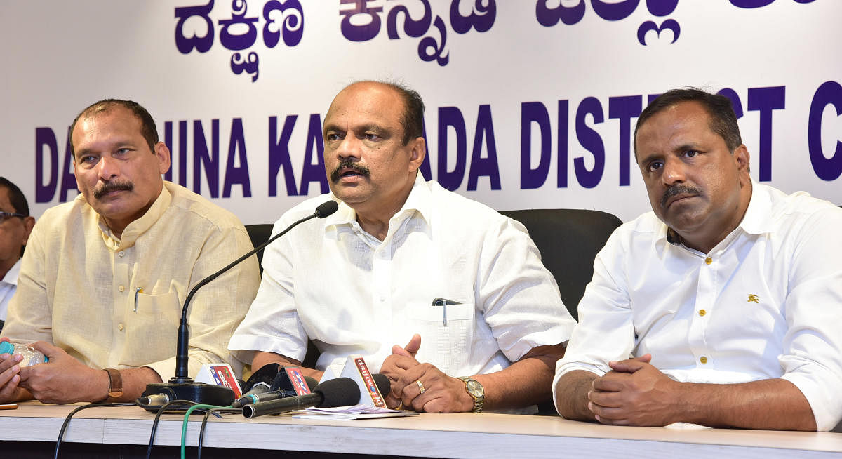 DCC President K Harish Kumar (centre) addresses reporters in Mangaluru on Tuesday.