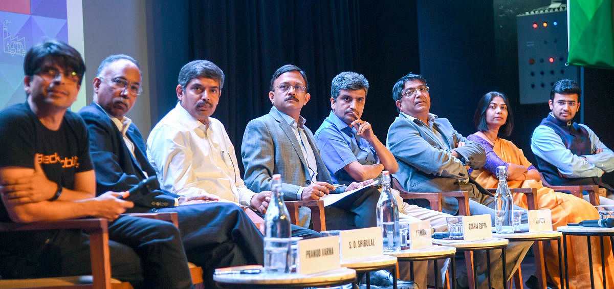(From left) Pramod Varma, S D Shibulal, V Ponnuraj, Gaurav Gupta, Ajay Seth, Bhaskar Rao, C Shikha and Tejasvi Surya at a panel discussion on Thursday. DH Photo/B H Shivakumar