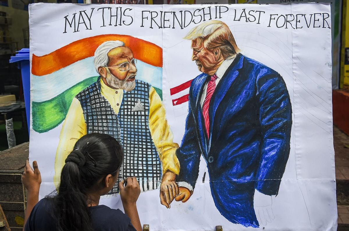A child makes a painting depicting US President Donald Trump and PM Narendra Modi, ahead of former's maiden visit to India, in Mumbai, Friday, Feb. 21, 2020. (Credit: PTI Photo)