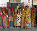 Women stand in a queue to cast their ballots outside a polling booth during the first phase of state elections at Sanand town in Gujarat on December 13, 2012. REUTERS