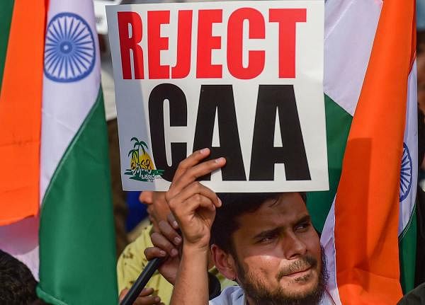 Protesters hold placards and raise slogans during a protest against CAA, NRC, NPR and violence in JNU campus, in Bengaluru, Monday, Jan. 13, 2020. (PTI Photo)