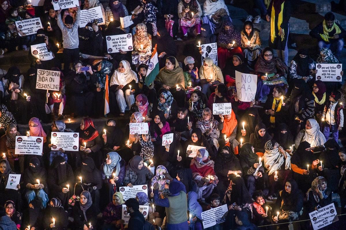 Muslim women take part in a candle light march in protest against the attack on Jamia students, CAA and NRC, at Jama Masjid, in New Delhi, Wednesday, Jan. 15, 2020. (PTI Photo)