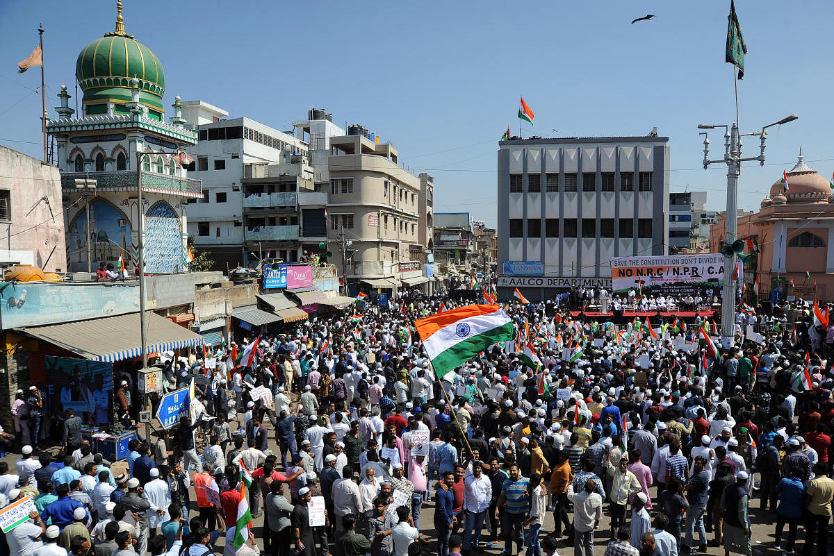 Hundreds take part in a protest against CAA at Shivajinagar in Bengaluru on Tuesday. Several shops in the area were shut in support of the protest. DH Photos/Pushkar V