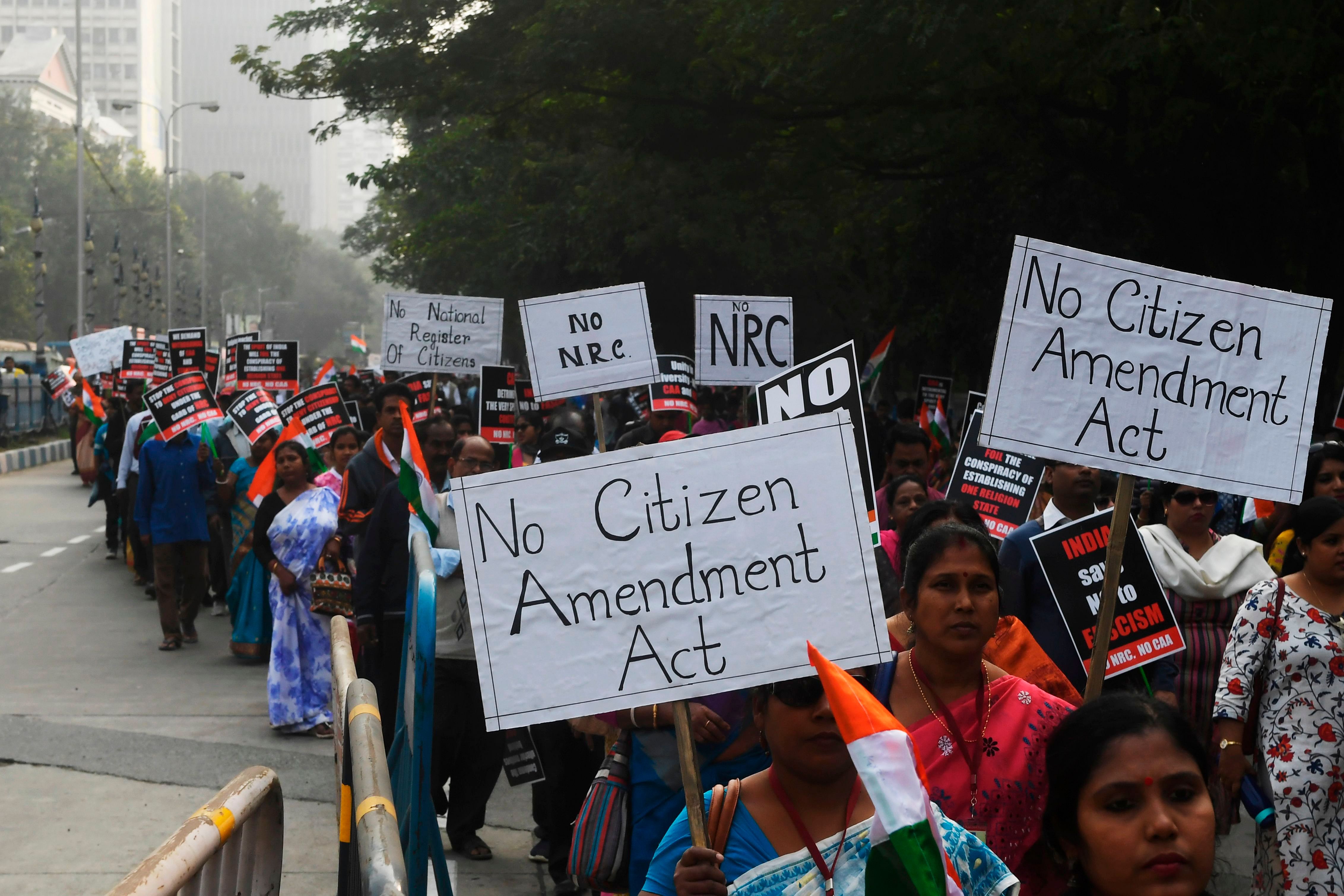 Members of the Christian community along with social activists hold placards and Indian flags as they take part in a rally to protests against the Indian government's Citizenship Amendment Act (CAA), in Kolkata. (PTI Photo)