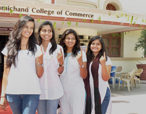 First time voters pose for a photograph after casting votes for Lok Sabha polls at a polling station in Ahmedabad on Wednesday. PTI Photo