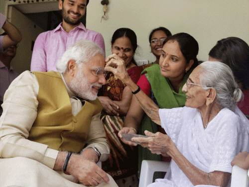 A victorious Narendra Modi seeks blessings of his mother Hiraba at her home in Gandhinagar. PTI photo