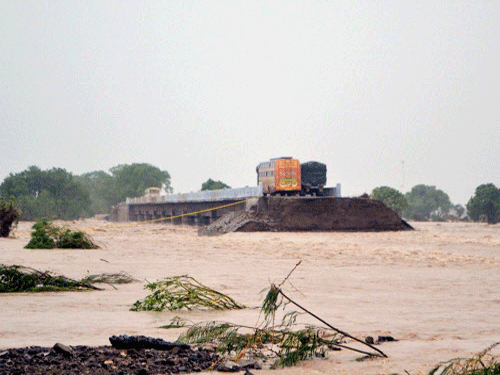 Marooned vehicles on a bridge after heavy rains created a flood like situation in Amreli district of West Gujarat. PTI photo
