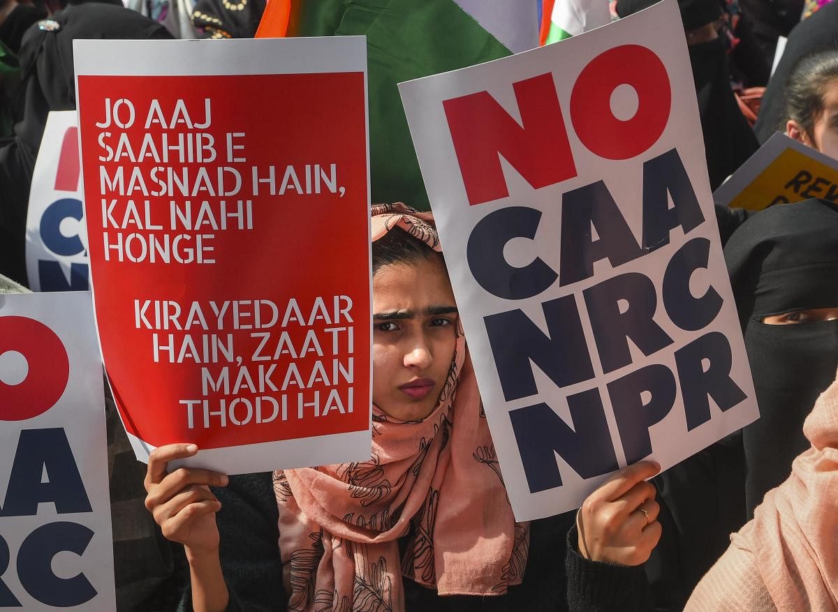 Protesters display placards during a demonstration against Citizenship (Amendment) Act and National Register of Citizens (NRC) (PTI File Photo)