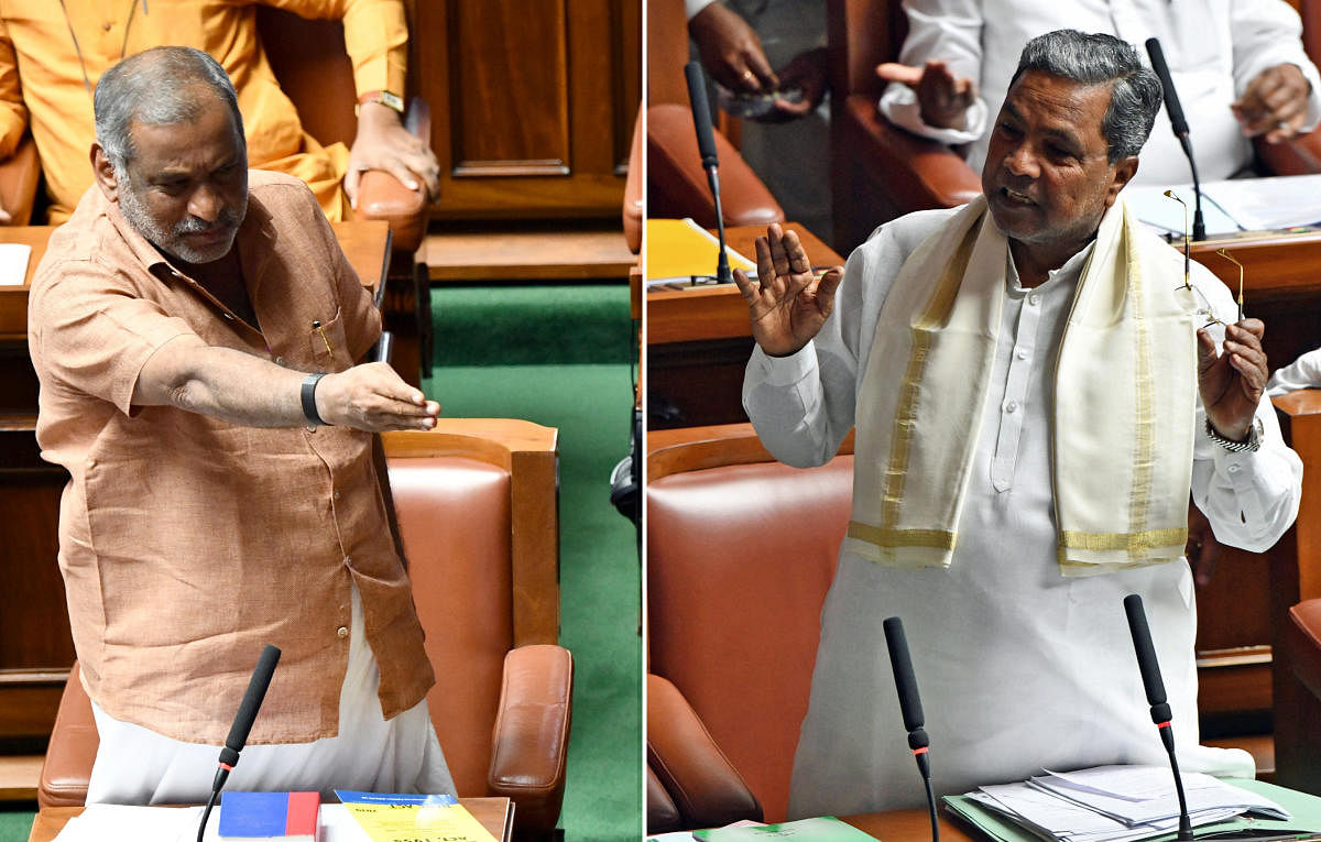 Law Minister J C Madhuswamy and Leader of the Opposition Siddaramaiah argue in the Assembly.