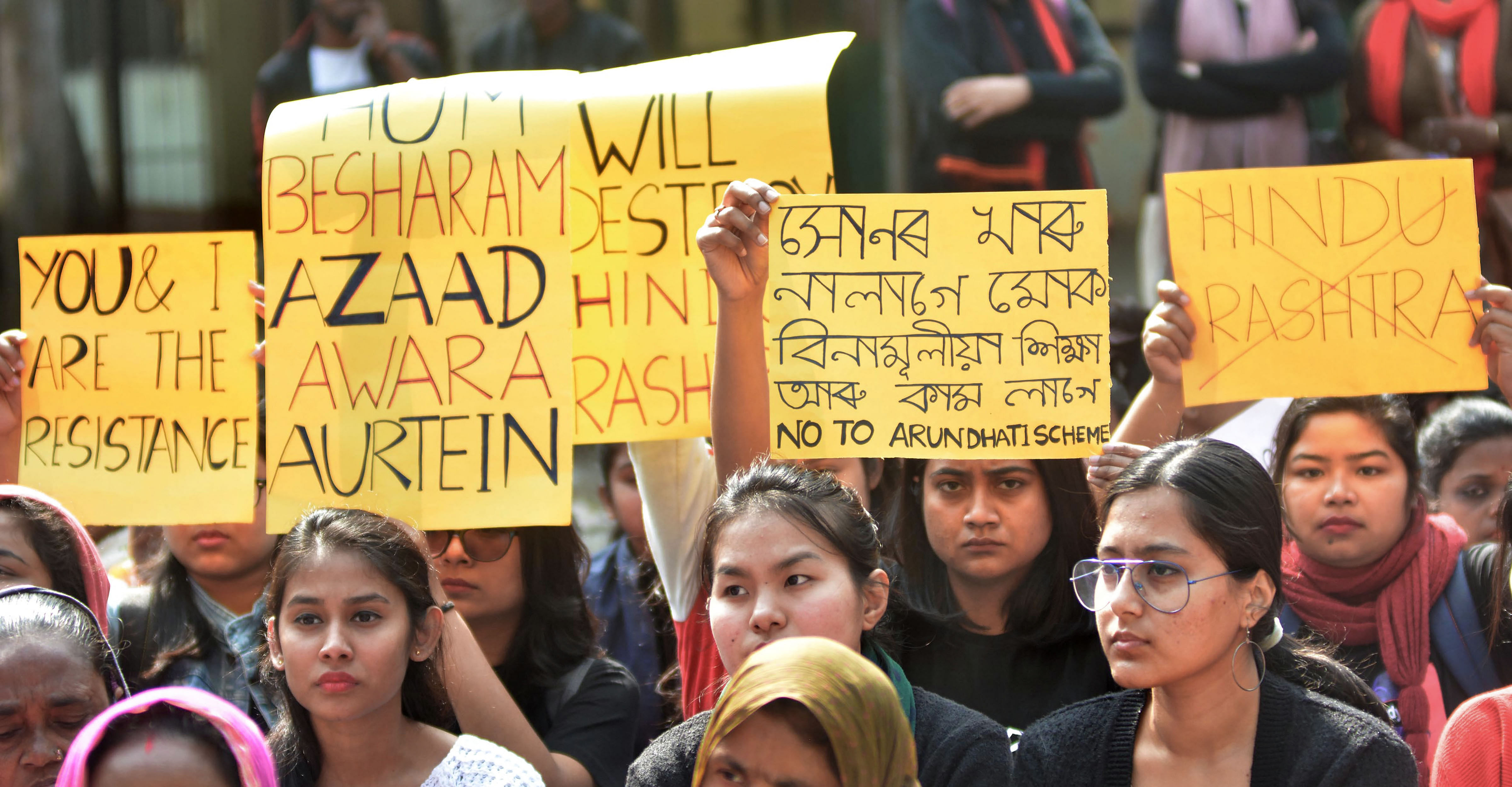 Protestors holding placards stage a demonstration against gender discrimination and Citizenship Amendment Act . (PTI Photo)