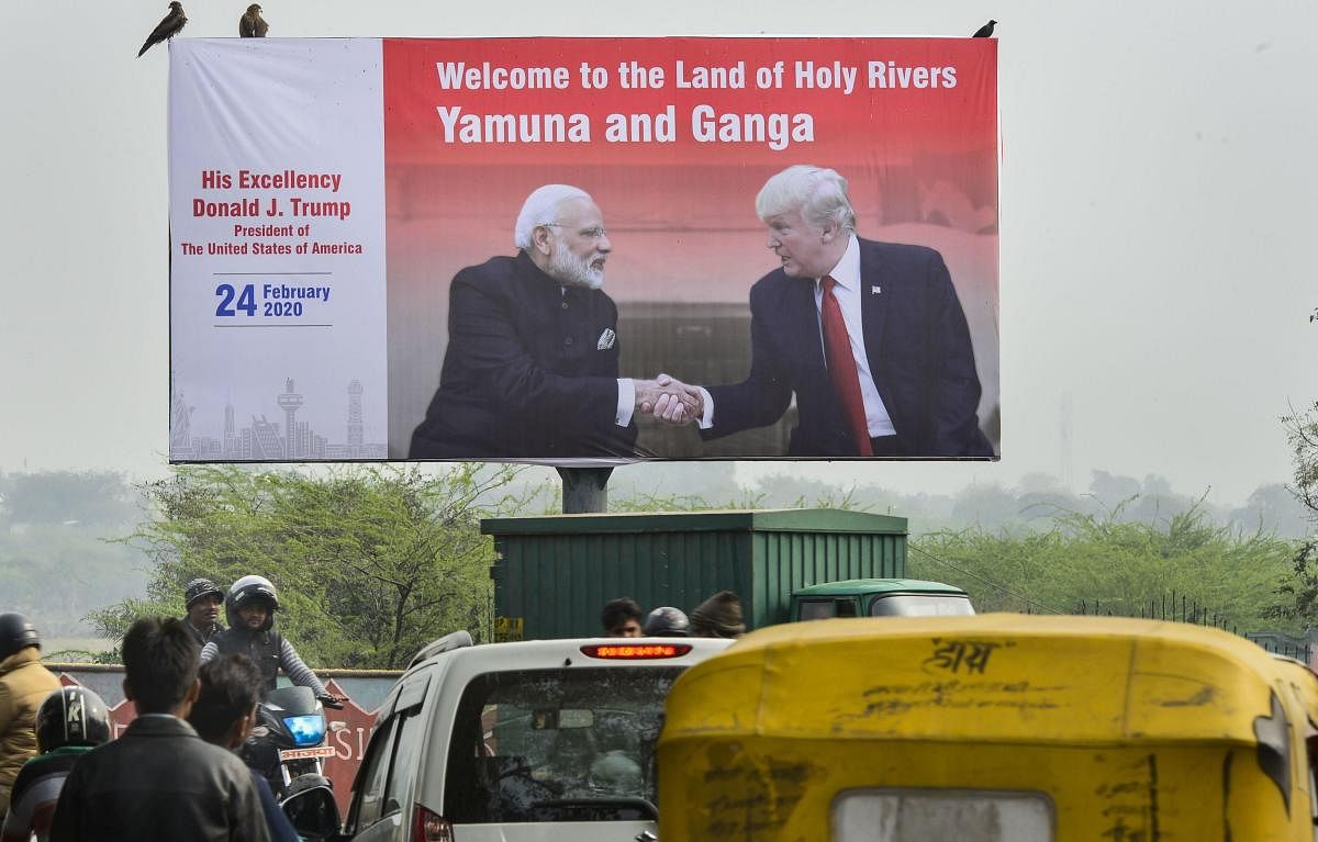 A billboard with the pictures of Prime Minister Narendra Modi and U. S. President Donald Trump put up along side a road, ahead of Trump’s visit to Agra. (PTI Photo)