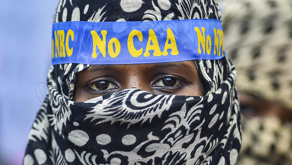 A muslim woman looks on during a protest against CAA, NRC, NPR, in Chennai. (PTI Photo)