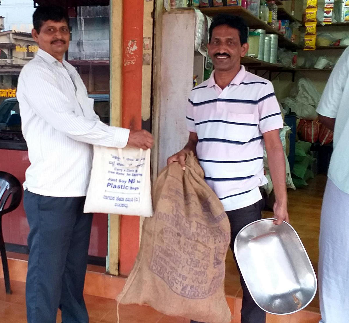 Shirva Gram Panchayat member K R Patkar handing over rice in exchange for plastic trash at Bantakal in Shirva.