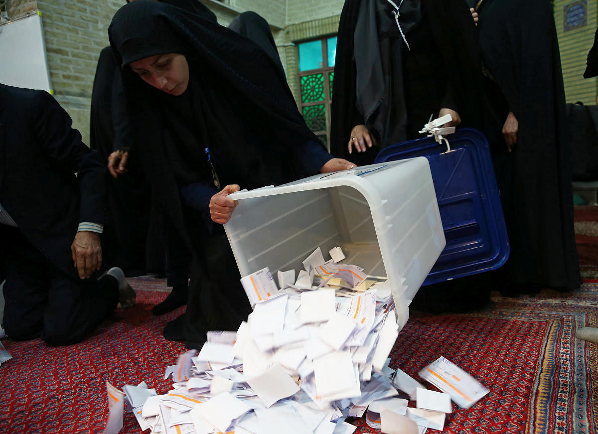 Poll workers empty full ballot boxes after the parliamentary election voting time ended in Tehran, Iran February 22, 2020. (Reuters Photo)