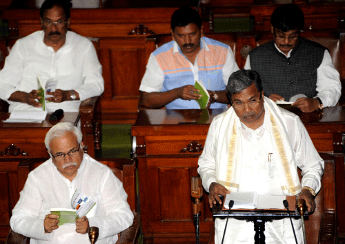 Chief Minister Siddaramaiah during the presentation of the State Budget at Legislative Assembly, at Vidhana Soudha in Bangalore on Friday. Minister R V Deshpaande is also seen. DH photo