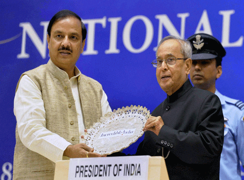 President of India Pranab Mukherjee is presented a memento by Tourism Minister Mahesh Sharma during National Tourism Awards 2013-2014 at Vigyan Bhavan in New Delhi on Friday. PTI Photo