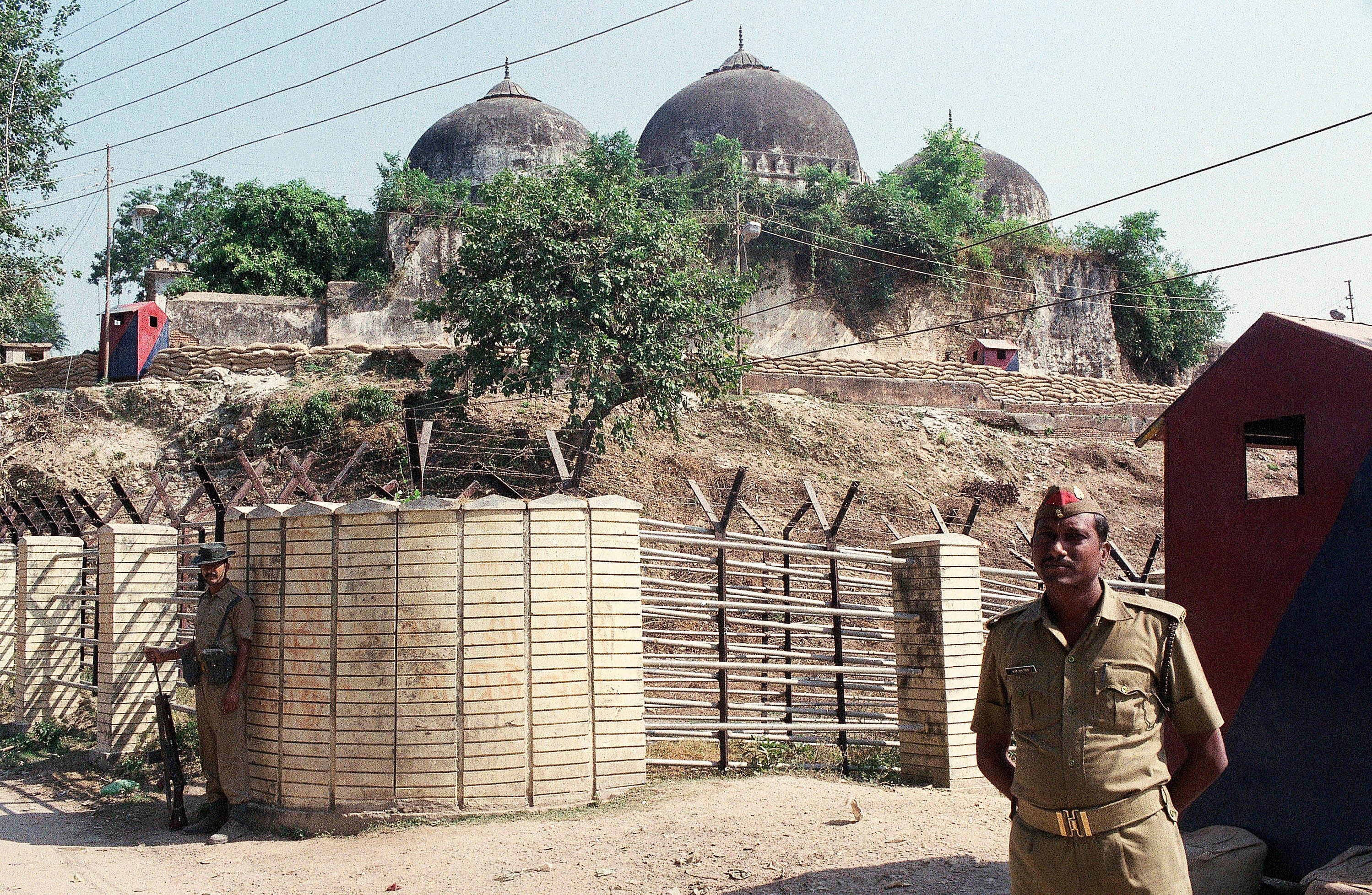 Indian security officer guards the Babri Mosque in Ayodhya, closing off the disputed site claimed by Muslims and Hindus. (PTI Photo)