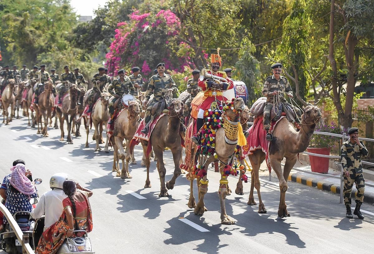 Border Security Force (BSF) camel contingent patrol a street, ahead of US President Donald Trump’s maiden visit to India, in Ahmedabad. (PTI Photo)