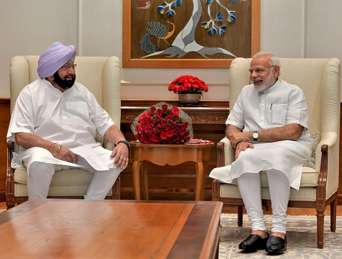 Prime Minister Narendra Modi with Punjab Chief Minister Amarinder Singh, in New Delhi on Monday, June 18, 2018. (PTI Photo)