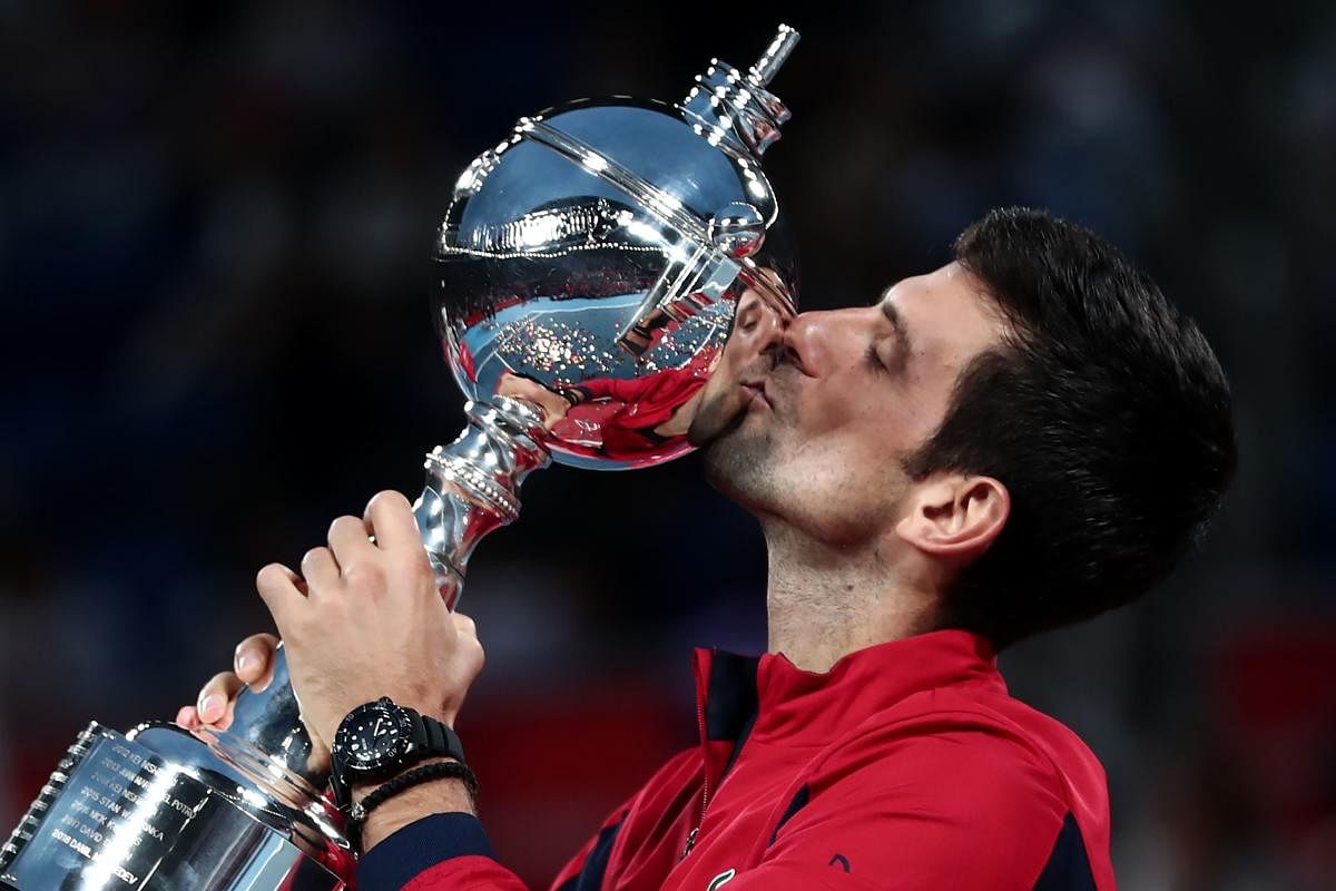 Serbia's Novak Djokovic kisses the trophy after winning the men's singles final against John Millman of Australia at the Japan Open tennis tournament in Tokyo on October 6, 2019. (AFP Photo)