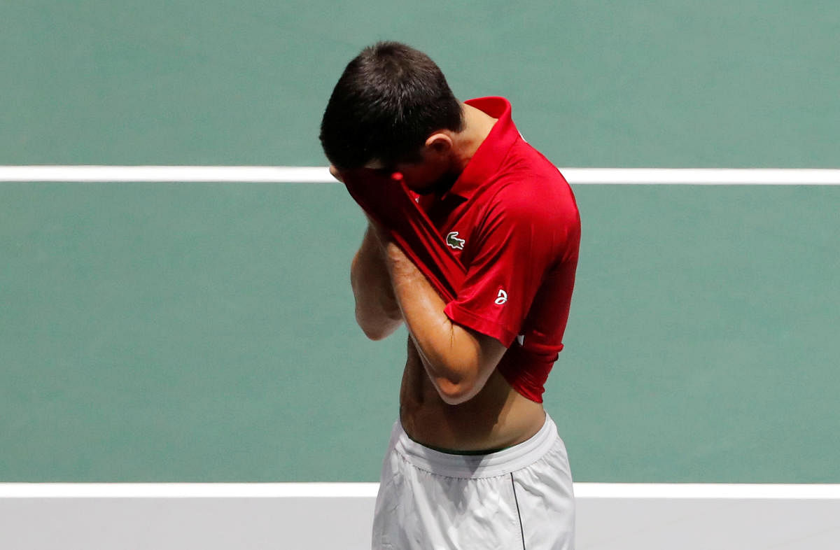 Serbia's Novak Djokovic reacts after losing his doubles match against Russia's Andrey Rublev and Karen Khachanov. (Reuters Photo)
