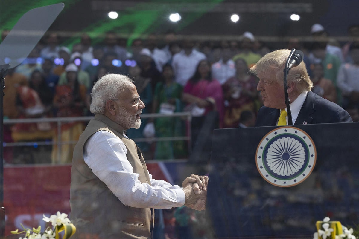 U.S. President Donald Trump and Indian Prime Minister Narendra Modi shake hands during a "Namaste Trump," event at Sardar Patel Gujarat Stadium, Monday, Feb. 24, 2020, in Ahmedabad, India.AP/PTI