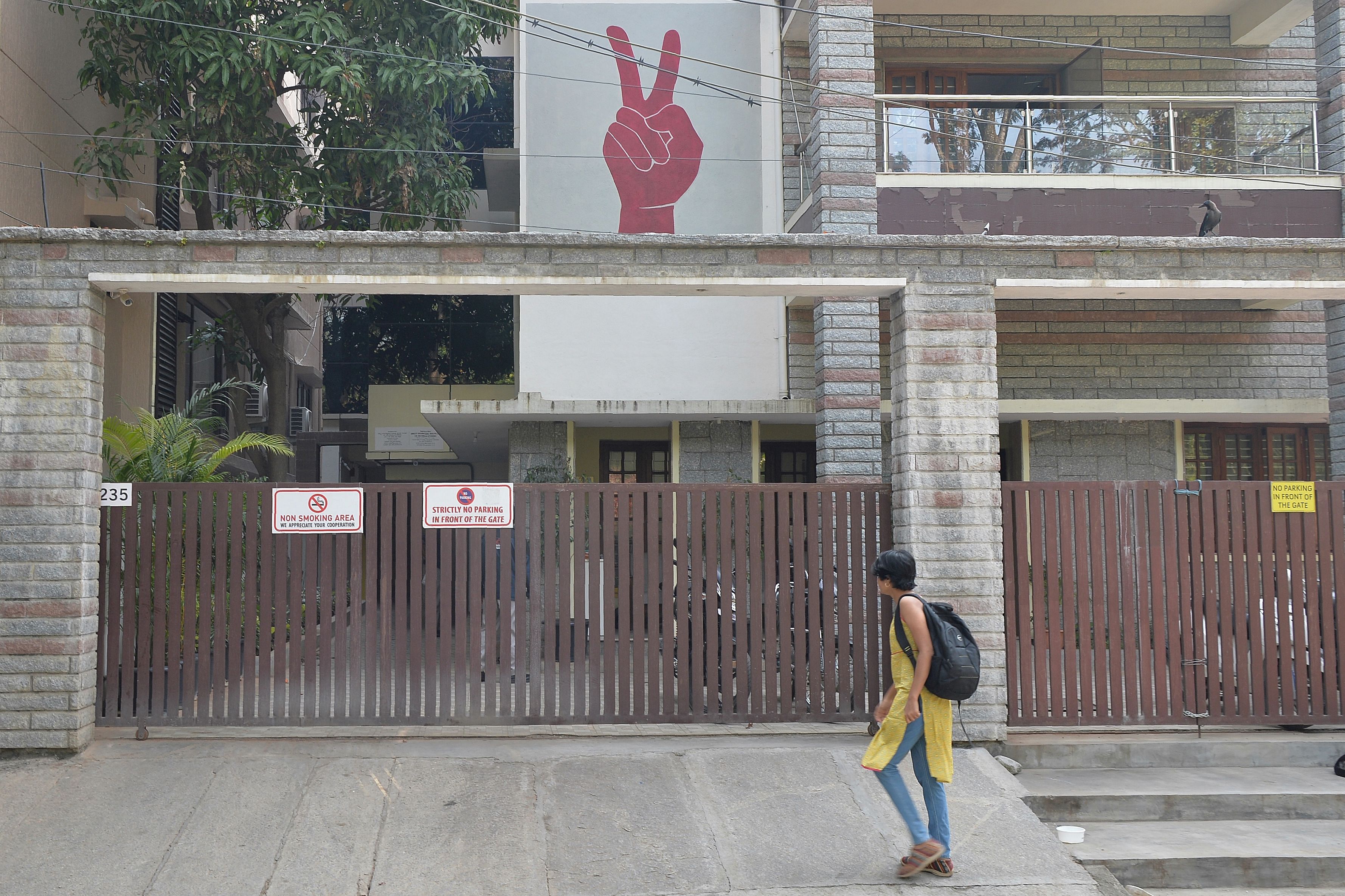 A pedestrian walks past the Amnesty International office in Bangalore. (AFP Photo)