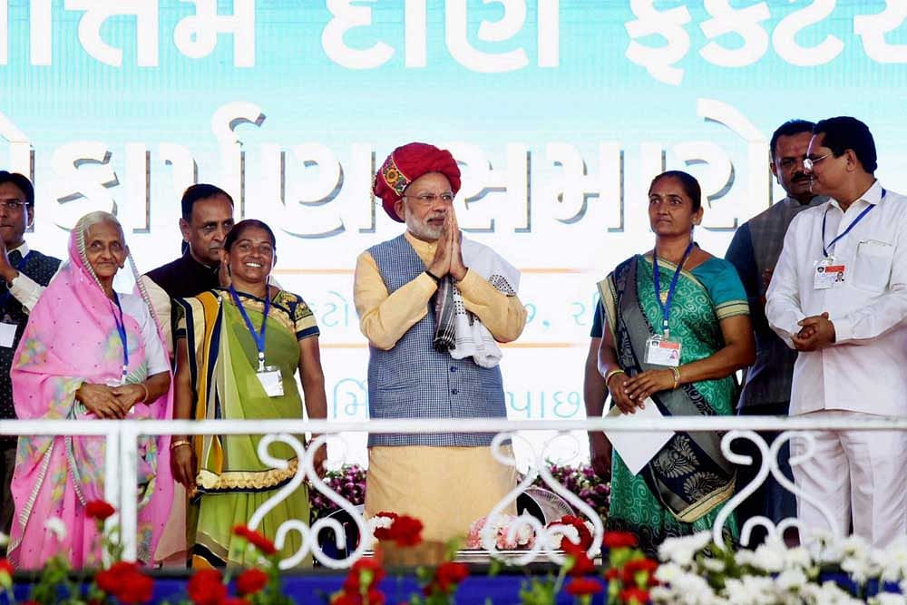 Prime Minister Narendra Modi being welcomed on stage at the public meeting in Ghogha, Gujarat. PTI photo.