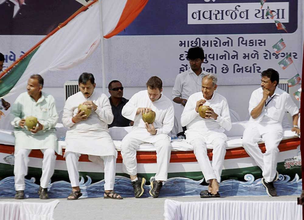 Congress vice-president Rahul Gandhi along with other leaders seen having coconut water during an interaction programme with fishermen at Valsad district, in Gujarat on Friday. PTI Photo