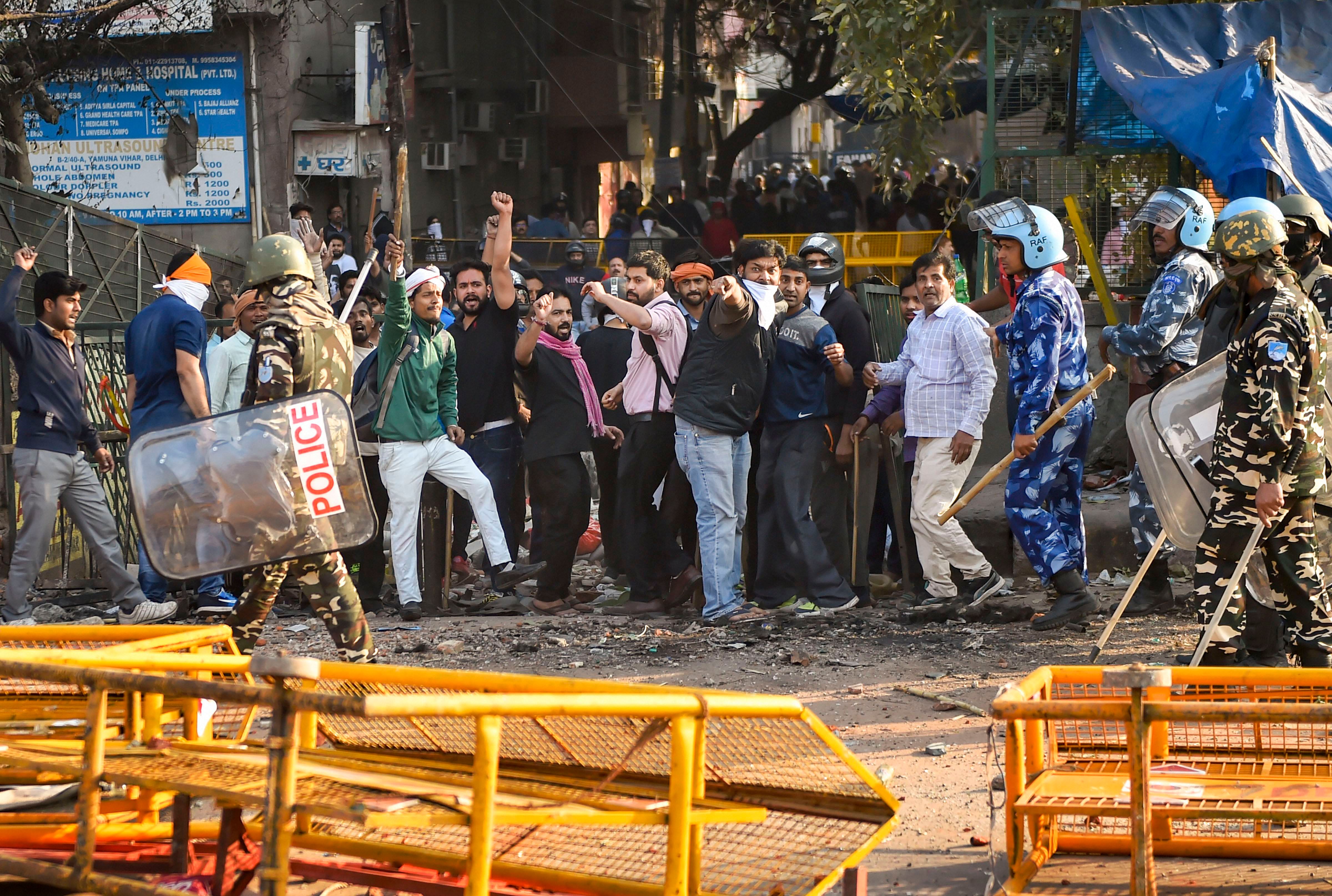 Security personnel stand guard during clashes between those supporting and against the Citizenship (Amendment) Act in north east Delhi, Tuesday, Feb. 25, 2020. The violence that started on Monday spread to many parts of north east Delhi, leading to death of nine people and injuries to many including police personnel. (PTI Photo)