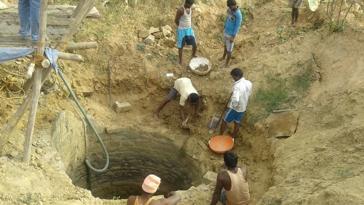 Well-diggers constructing an open-well in the city. Shubha Ramachandran
