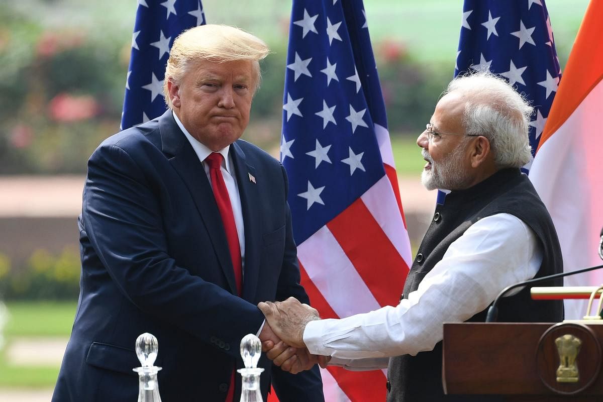 US President Donald Trump (L) shakes hands with India's Prime Minister Narendra Modi listens during a joint press conference at Hyderabad House in New Delhi on February 25, 2020. (Photo by AFP)