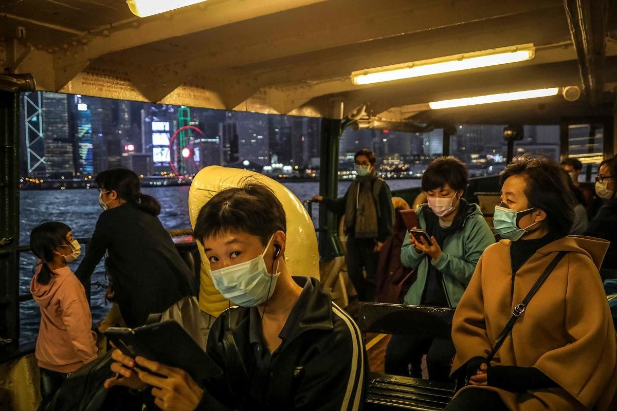 People wearing protective facemasks sit on a ferry crossing the Victoria Harbour in Hong Kong on February 22, 2020. Credit: AFP Photo