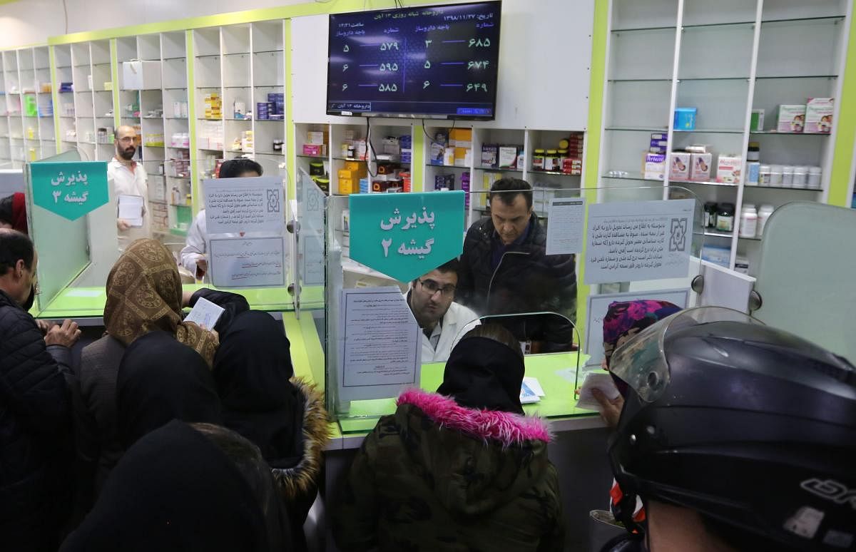 Iranians wait to get prescription drugs at the state-run "13 Aban" pharmacy in Tehran on February 19, 2020. AFP