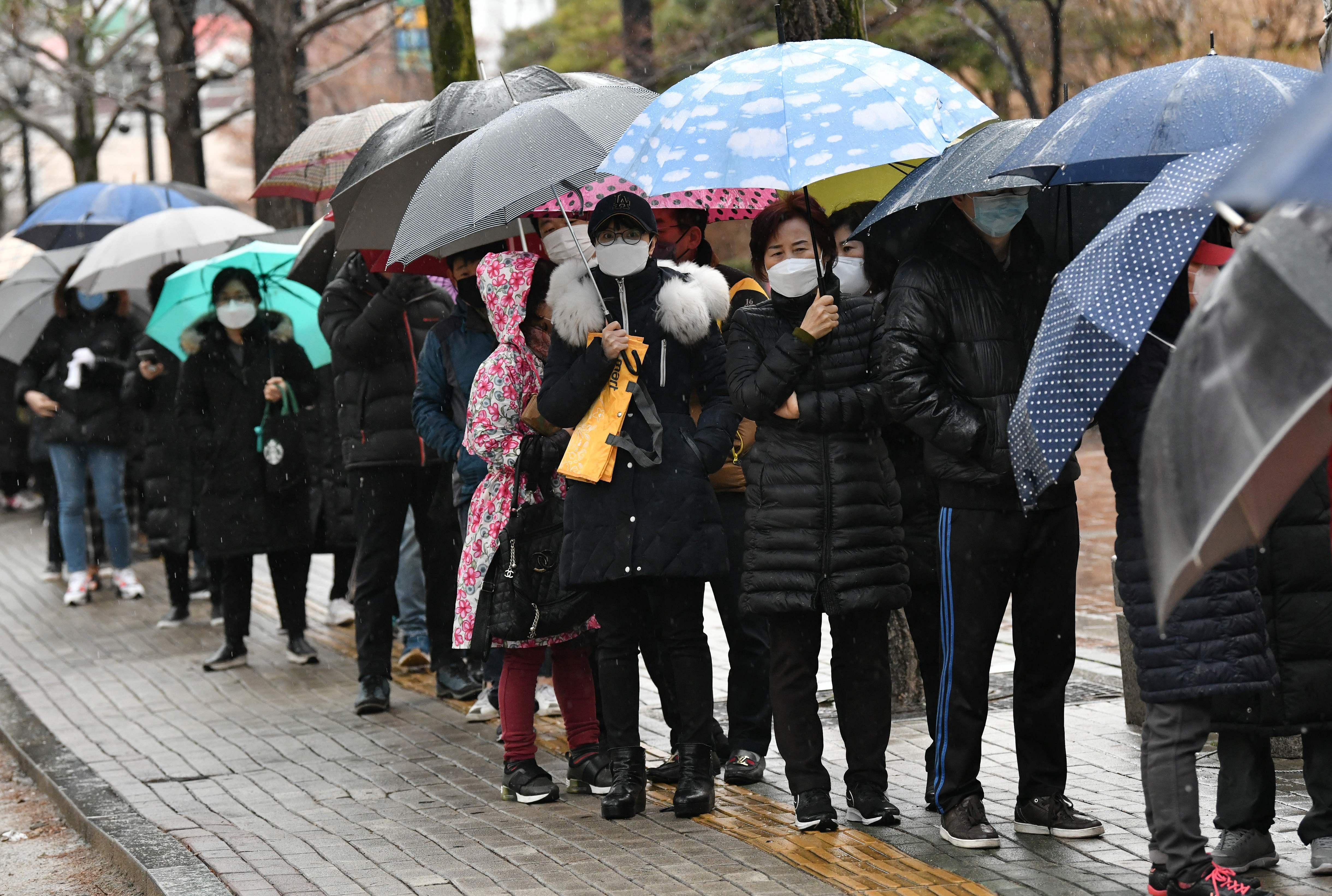 People wait in a line to buy face masks at a retail store in the southeastern city of Daegu on February 25, 2020. (Credit: AFP Photo)