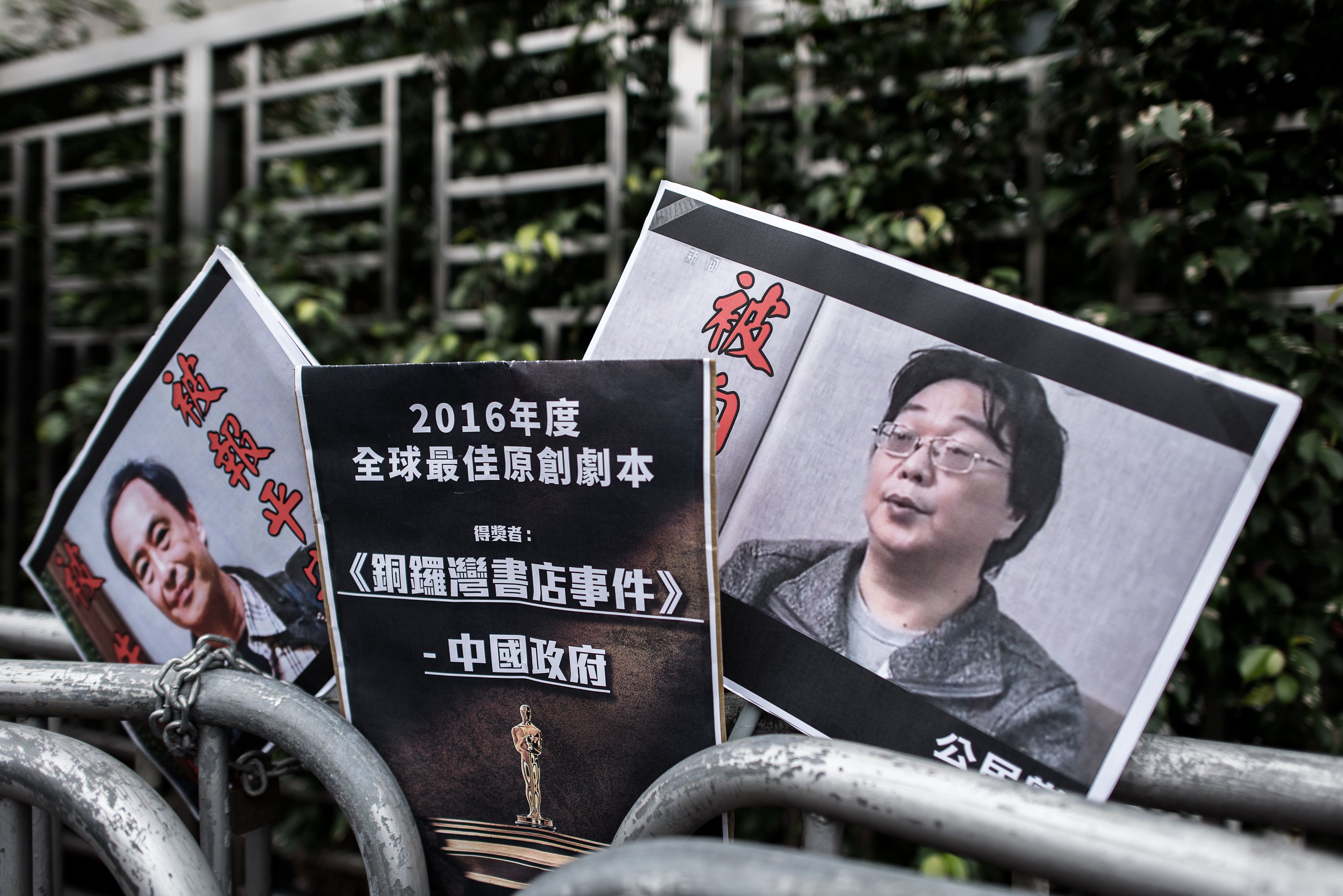 Placards showing missing bookseller Lee Bo (L) and his associate Gui Minhai (R) are seen left by members of the Civic party outside the China liaison office in Hong Kong. (Reuters Photo)