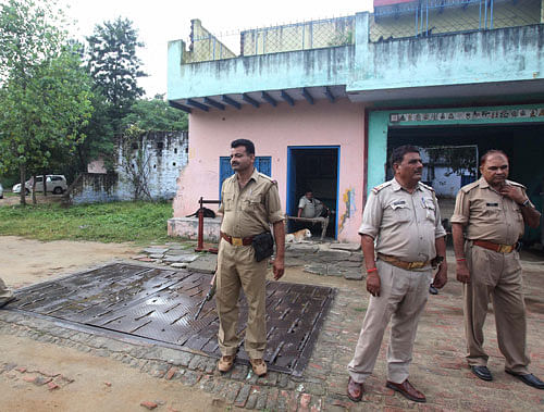 Security personnel keep vigil at Bisan Singh and and Ravinder Kumar's house at Kawal village from where the communal riot started, in Muzaffarnagar on Wednesday. PTI Photo.