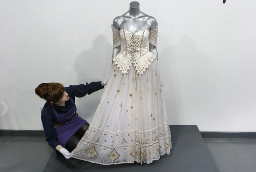 Assistant Lucy Bishop poses for a photograph with Princess Diana's Emanuel ball gown from the 1986 'Diaghilev' collection at Kerry Taylor Auctions in London. Reuters photo