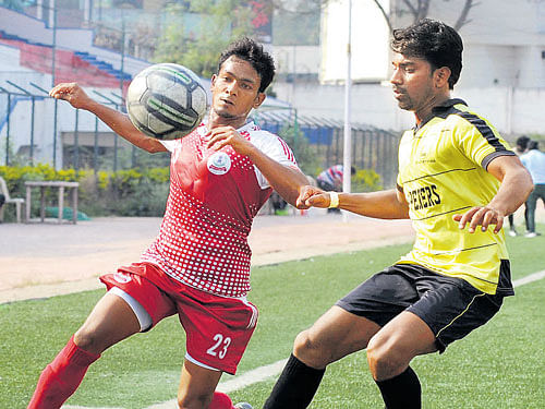 Keen Tussle Income Tax SC's AD Kumar (left) vies for the ball with Steephan of SAI . DH photo