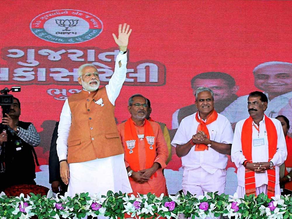 Prime minister Narendra Modi waves at the crowd during a public meeting in support of BJP candidates for Assembly polls, in Bhuj on Monday. PTI Photo