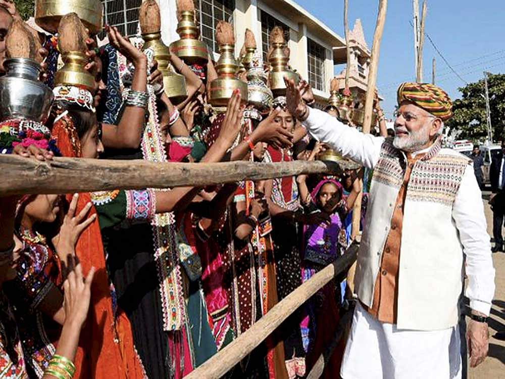 Prime minister Narendra Modi meeting public during his election campaign for the forthcoming Assembly polls in Bhuj on Monday. PTI Photo