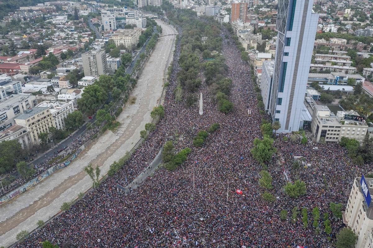 In this aerial view thousands of people protest in Santiago, on October 25, 2019, a week after protests started. - Demonstrations against a hike in metro ticket prices in Chile's capital exploded into violence on October 18, unleashing widening protests over living costs and social inequality. (Photo by Pedro Ugarte / AFP)