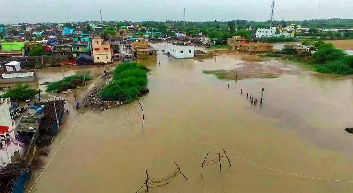  An aerial view of a flooded Rajpara village after heavy monsoon rainfall, in Gir-Somnath district on Wednesday. PTI Photo