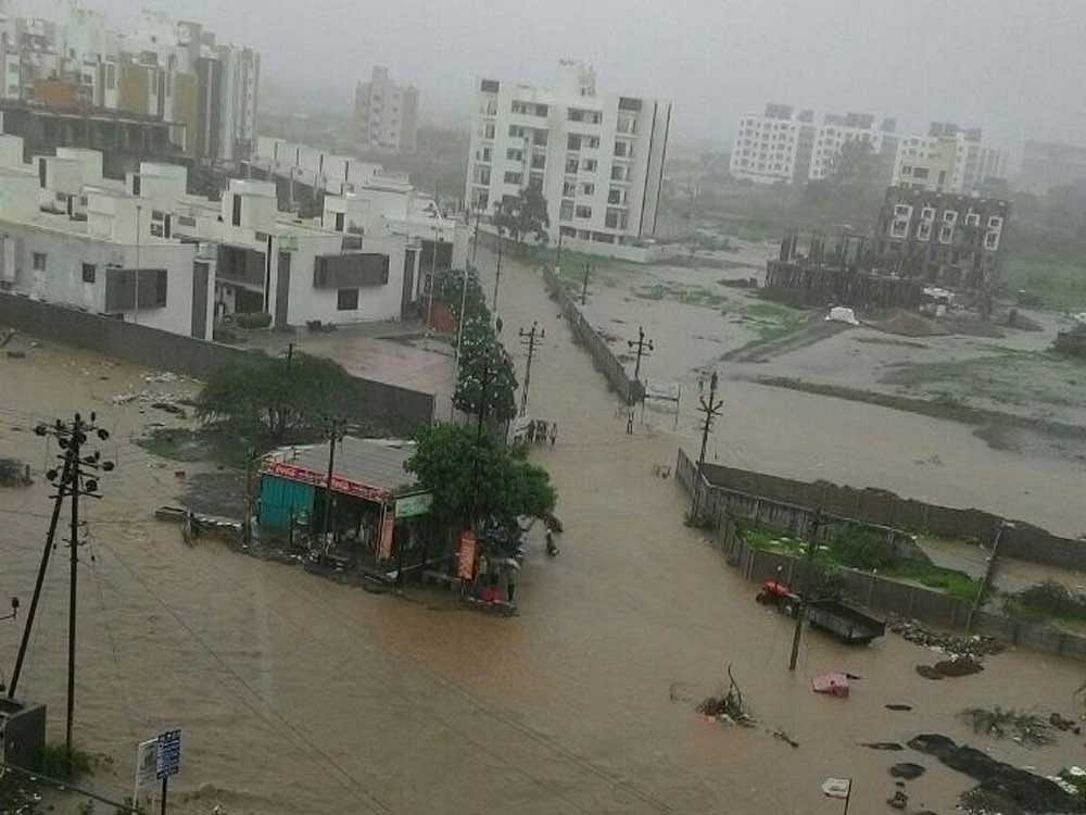 Ahmedabad, which remained relatively untouched by rain this season, received heavy downpour measuring over 4 inches in three hours post afternoon. The streets were waterlogged and life came to a standstill. (DH File Photo)